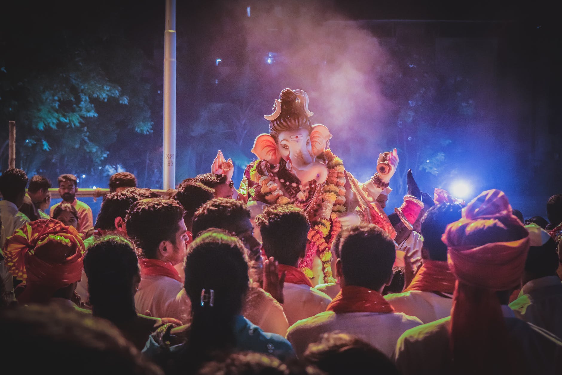 photo of people standing in front of ganesha statue